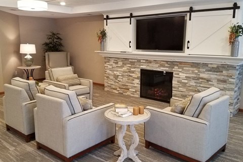 a living room with couches and chairs and a fireplace