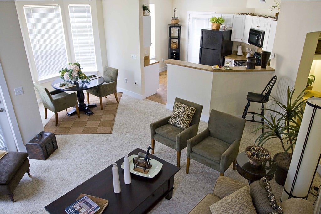 an open living room with a kitchen and a dining room