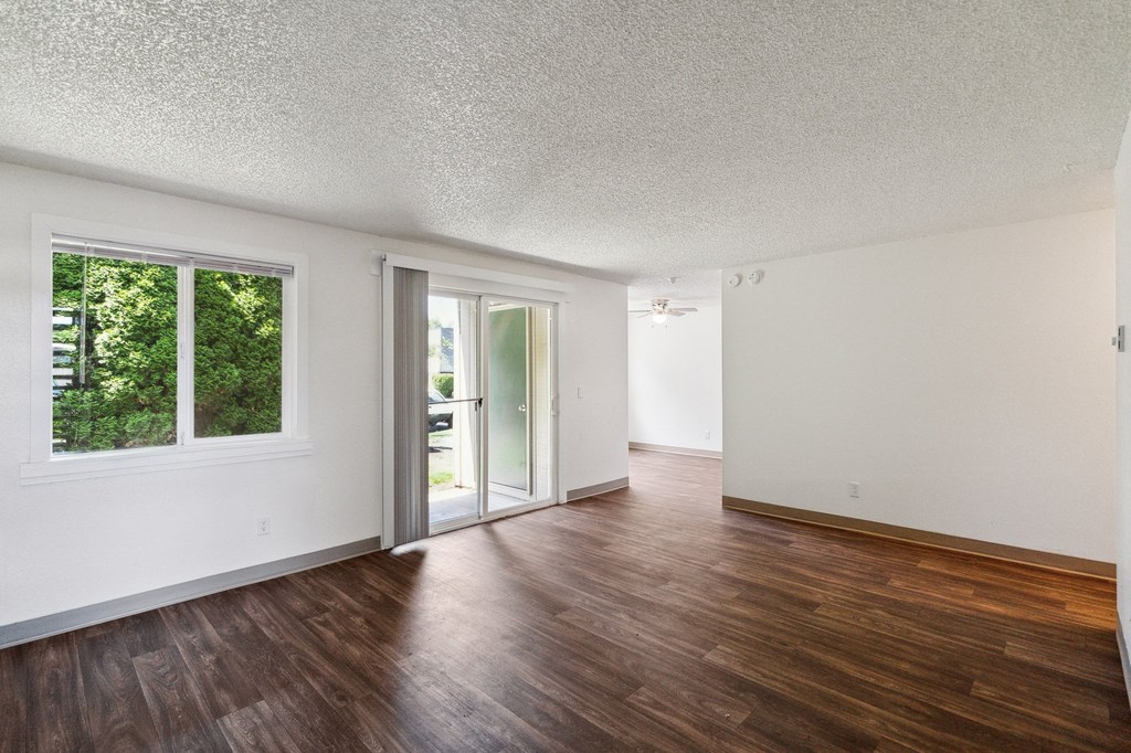the living room and dining room of an apartment