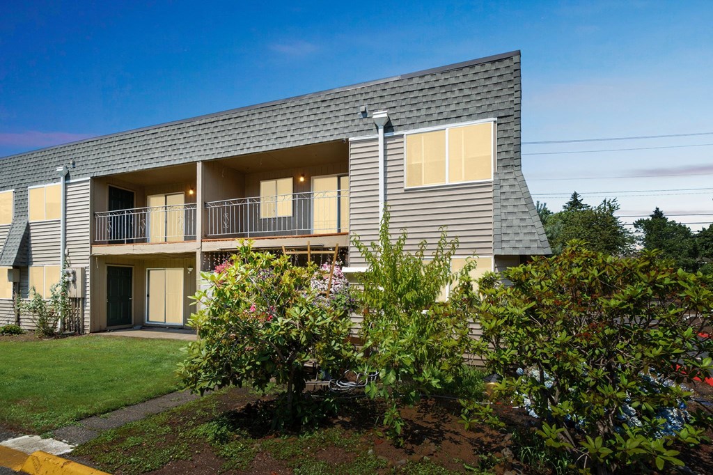 the exterior of a house with a yard and trees