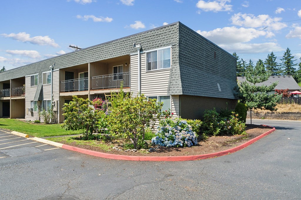 the front of an apartment building with a roundabout in front of it