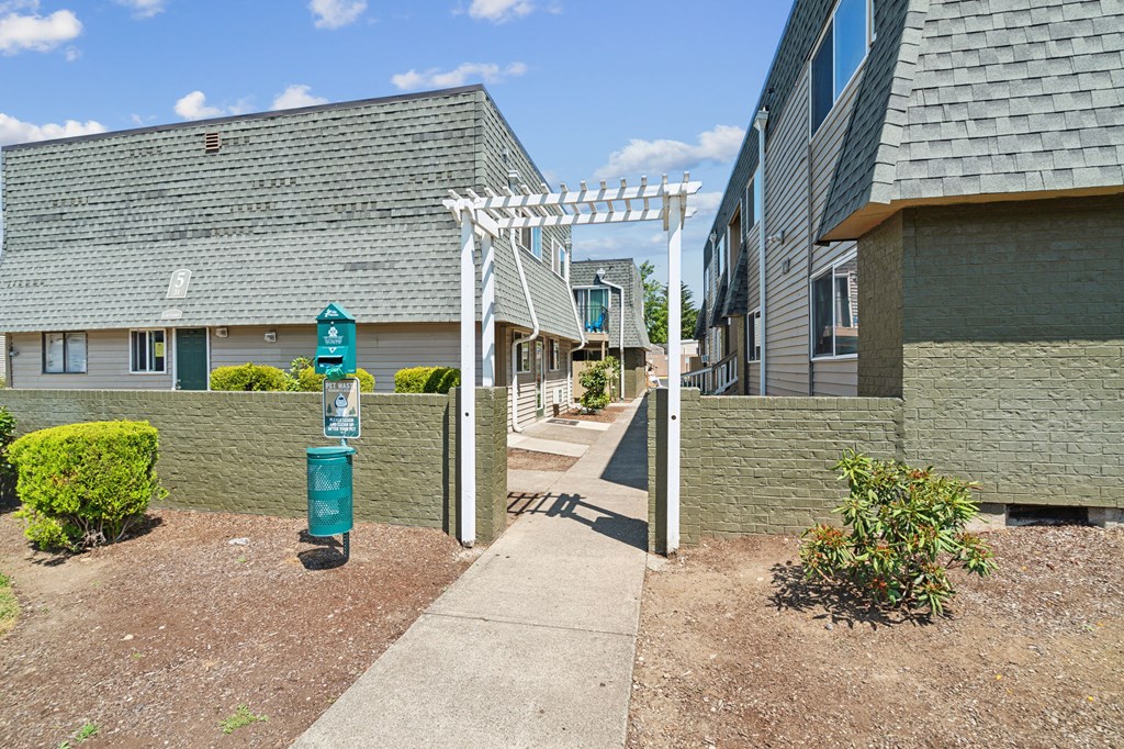 a walkway between two buildings with a blue fire hydrant