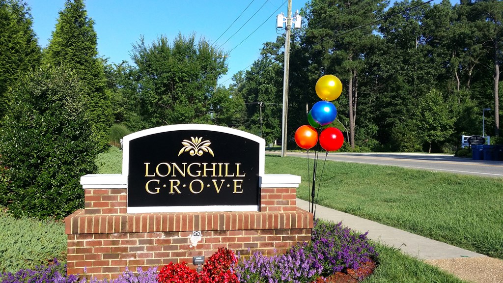 the sign at the entrance to long hill grove with balloons