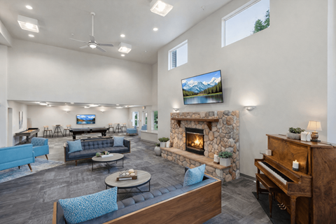 A living room with a fireplace and a television mounted on the wall.