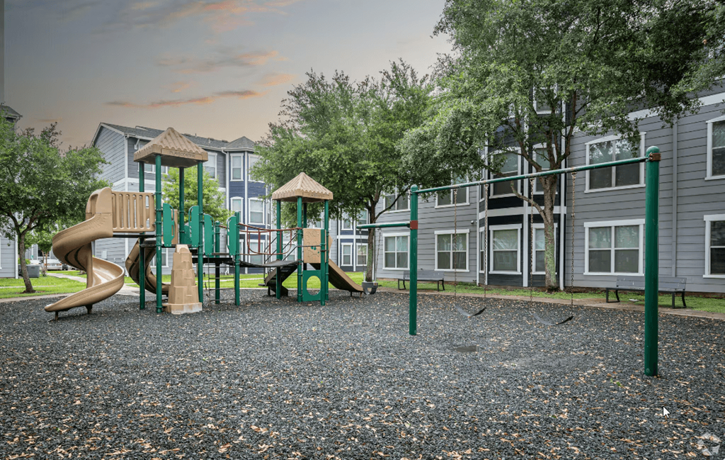 a playground at the whispering winds apartments in pearland, tx