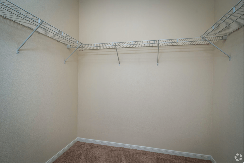 a spacious walk in closet at the whispering winds apartments in pearland, tx