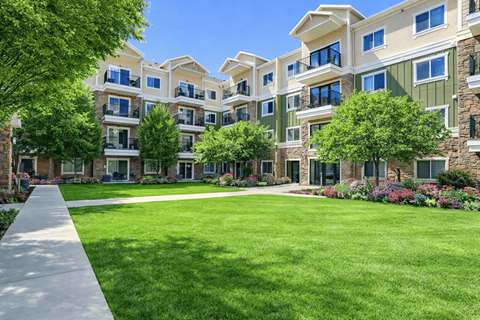 A large grassy area in front of apartment buildings.