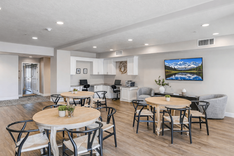 Community workspace with desks and lounge seating at The Beckstead Apartments, South Jordan