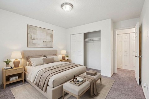 Bedroom with neutral tones and open closet at Carver Ridge Townhomes Apartments, Minnesota