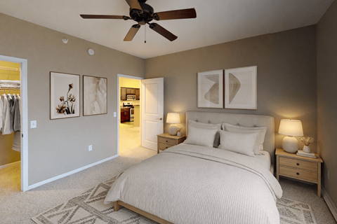 A bedroom with a large bed and a ceiling fan.