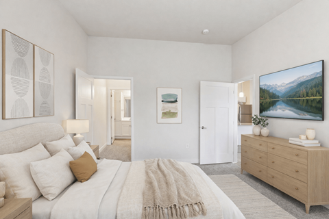 A bedroom with a large bed and a painting on the wall.