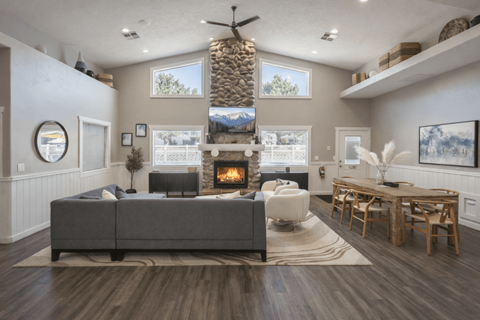 A modern living room with a grey sofa and a fireplace.