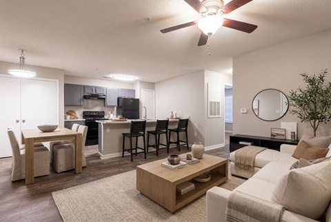 A living room with a dining table and chairs.
