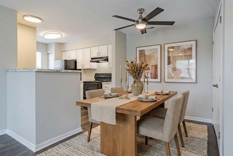 A dining room with a wooden table and chairs at Arbors at Hickory Creek Apartments , Illinois, 60484