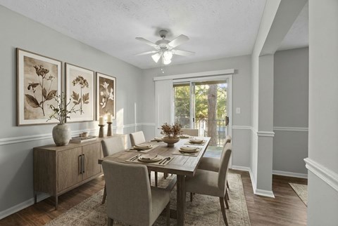 A dining room with a table set for four.