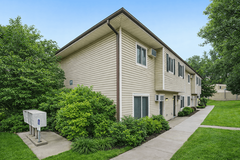 Two story residential building with beige siding at Carver Ridge Townhomes Apartments, Chaska, Minnesota