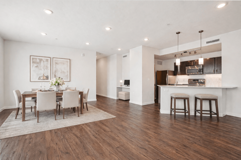 A modern kitchen with a dining table set for four.