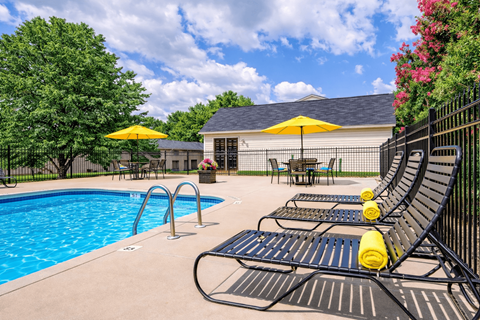 Resort style swimming pool with lounge chairs at Crestview Huntington Apartments, Concord