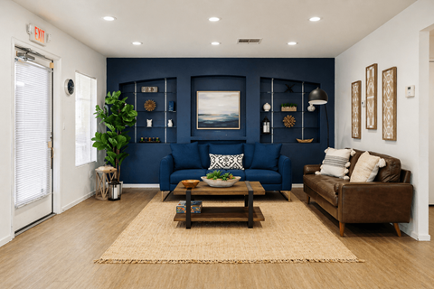 A living room with a blue couch and a brown couch.