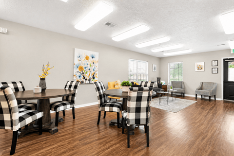 A dining room with a table set for six people.