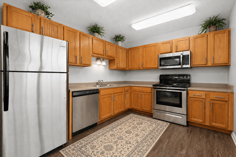 A kitchen with wooden cabinets and a white refrigerator.