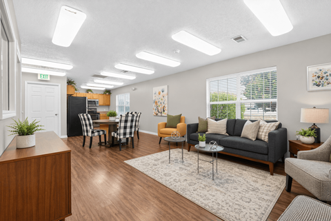 A well-lit living room with a variety of furniture and decor.