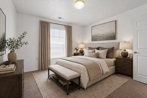 A bedroom with a large bed and a painting on the wall.