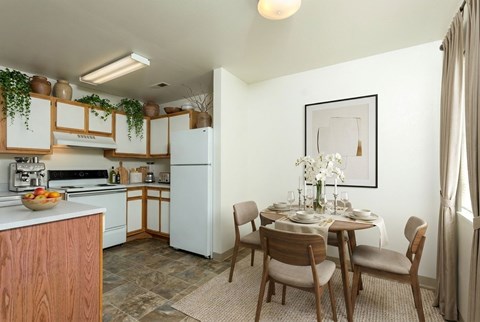 A kitchen with a dining table set for four.