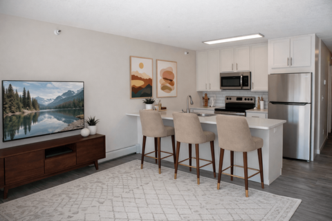 A kitchen with a dining table and chairs.