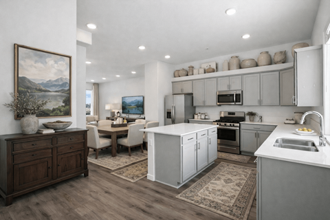 A modern kitchen with a dining table and chairs in the middle.