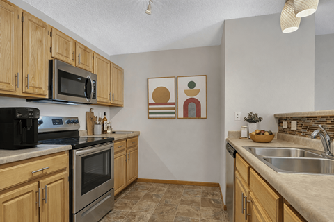 A kitchen with wooden cabinets and a black oven.