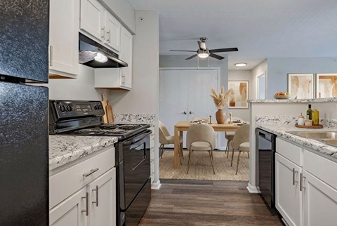A kitchen with a table and chairs in the middle of it.