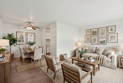 A living room with a dining table and chairs.