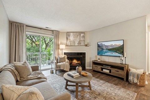 A living room with a fireplace and a painting on the wall.