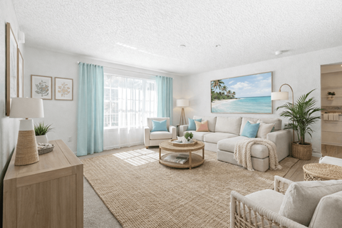 A living room with a large painting of a beach scene on the wall.