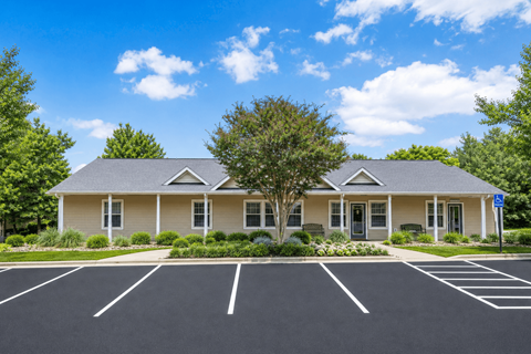 A building with a parking lot in front of it.