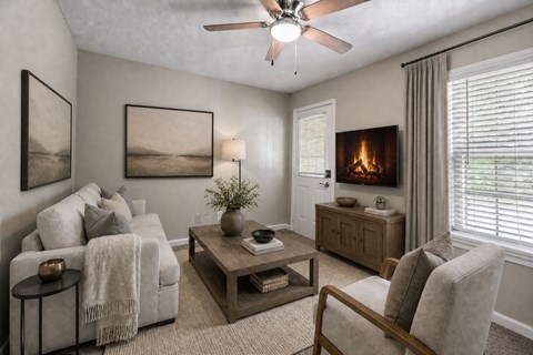 A living room with a fireplace and a painting on the wall.