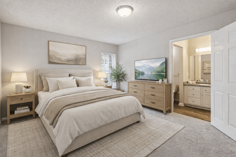 A bedroom with a large bed, a dresser, and a mirror.