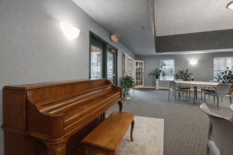 A room with a piano and a bench in front of it.