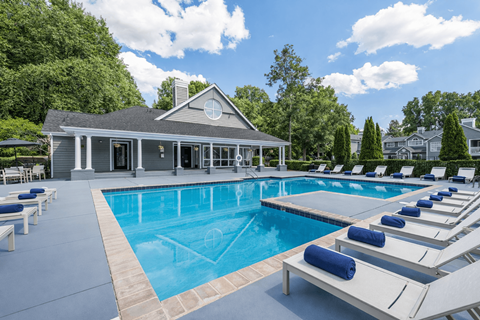 Resort style swimming pool with sun loungers at Delta Crossing Apartments, North Carolina