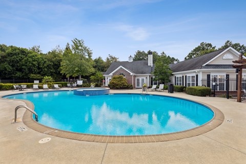 A large swimming pool in front of a house.