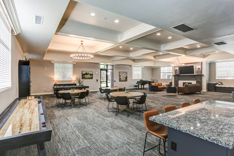 Community clubhouse with game tables and seating areas at The Beckstead Apartments, Utah, 84095