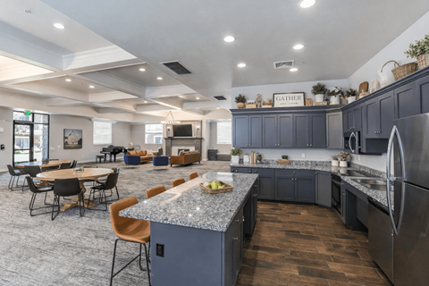 A modern kitchen with dark blue cabinets and a central island.