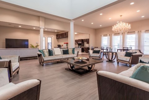 A spacious living room with a central coffee table and multiple seating options.