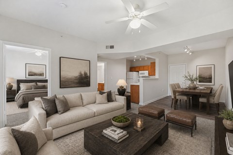 A living room with a white couch and a brown coffee table.