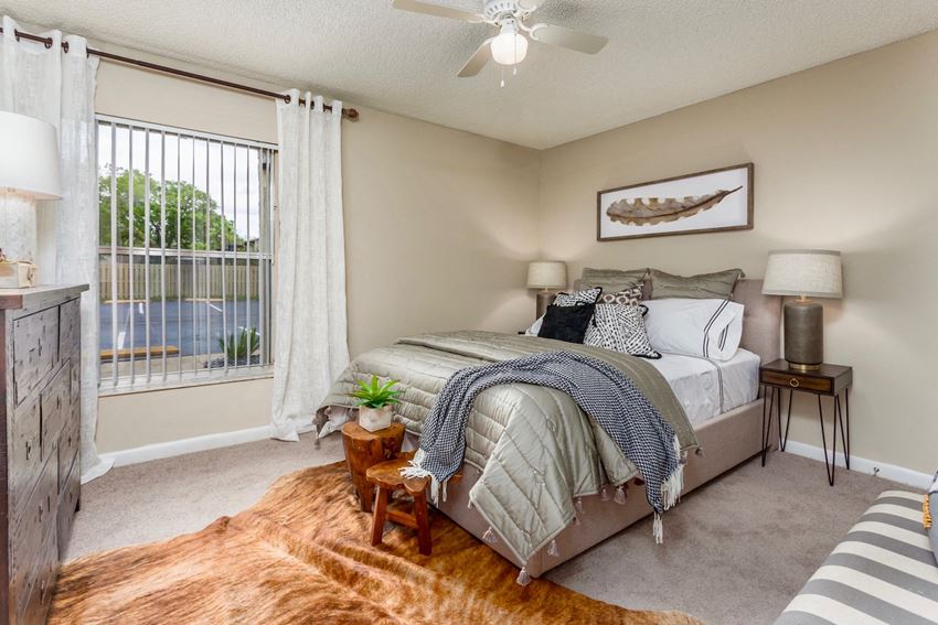 a bedroom with a large window and a bed