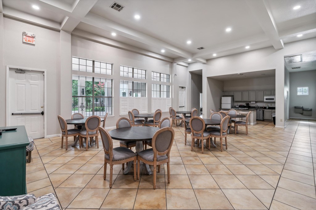 the clubhouse has a large dining room with tables and chairs