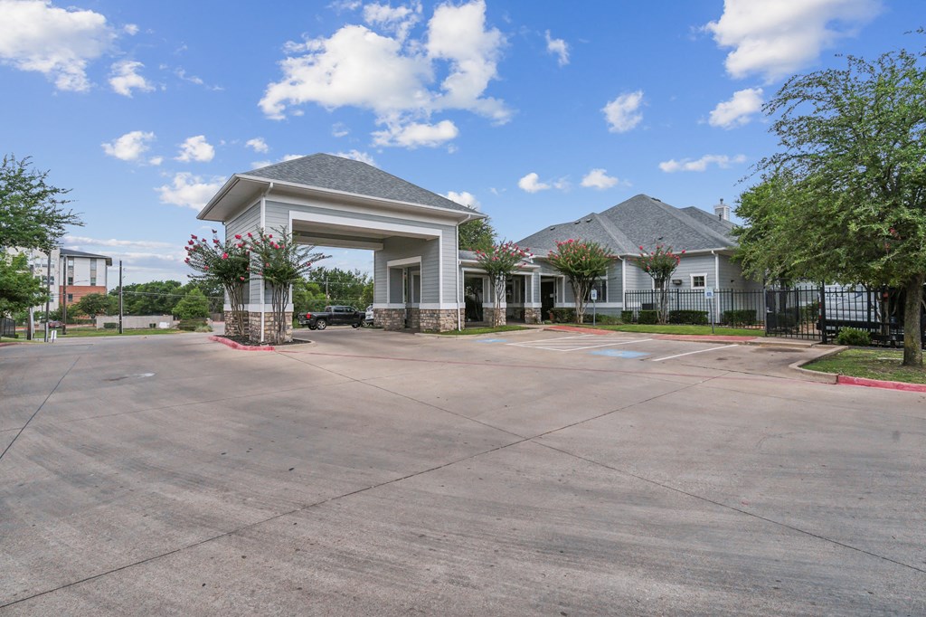 an empty parking lot with a building in the background