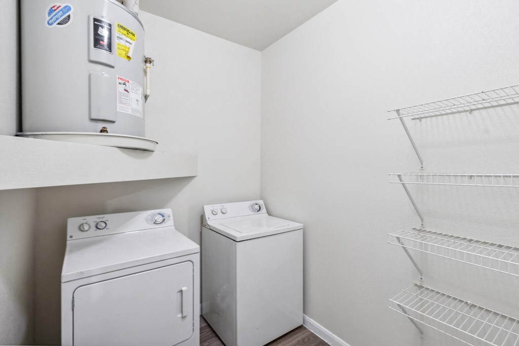 a room with a washer and dryer and a refrigerator in it and a