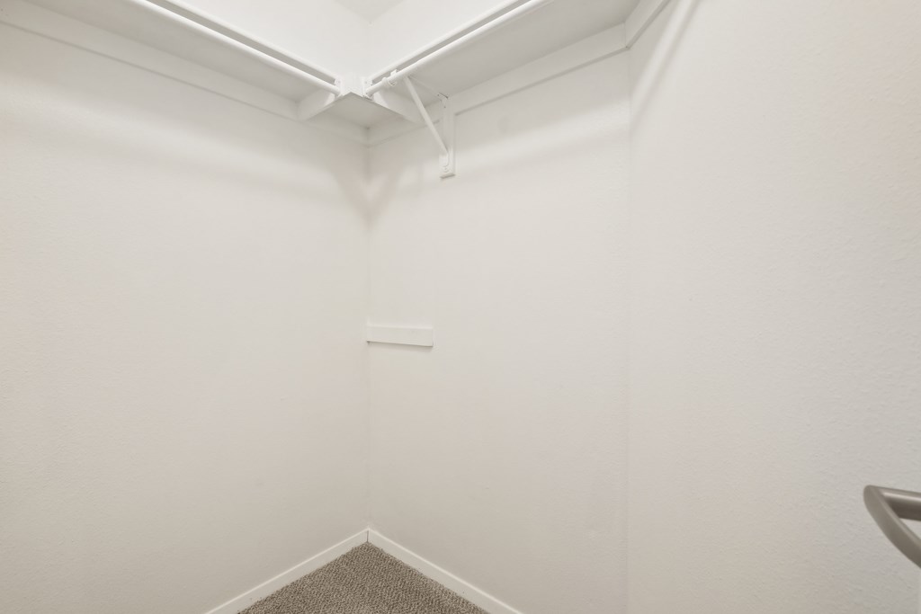 A white room with a carpeted floor and a white ceiling.